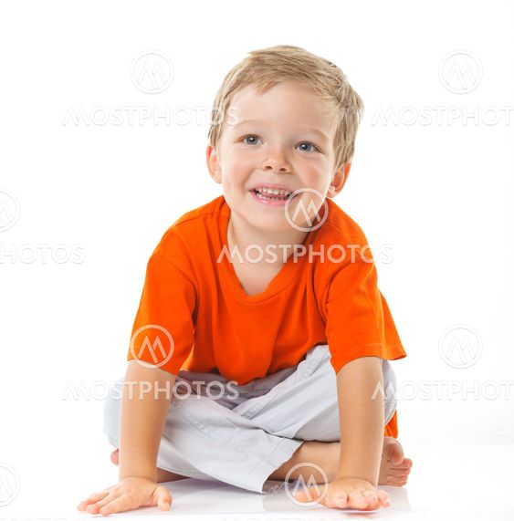 Happy boy sitting on the floor