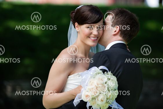 Man Kissing Wife on Cheeks