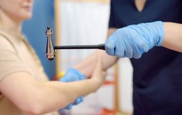 A woman at an appointment with a neurologist. A doctor...