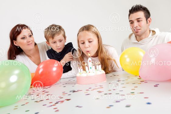 Young family celebrating birthday at home