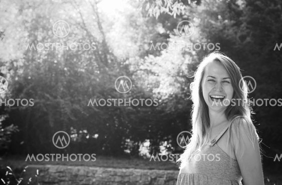 Smiling blond young woman in a park