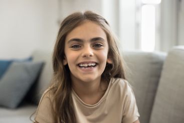 Head shot portrait laughing pretty little girl