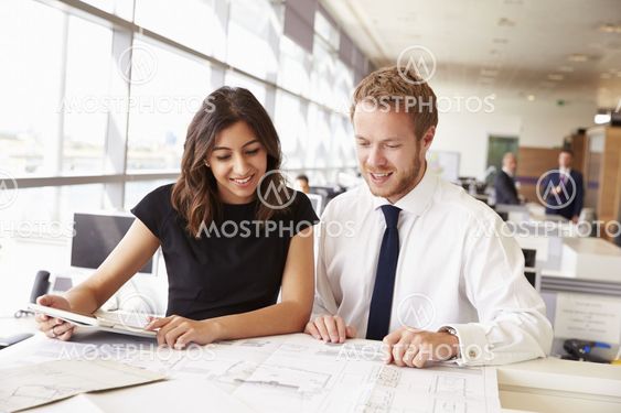 Two young architects working together in an office