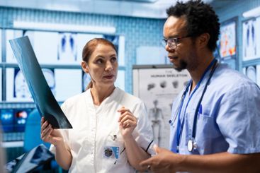 Medical professionals analyzing anatomy x ray scans to...
