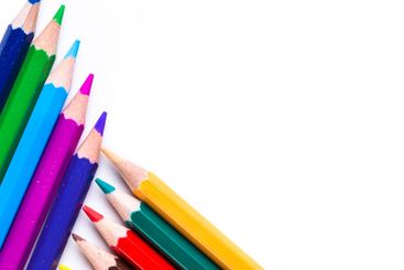 Collection of colorful pencils arranged on a white...