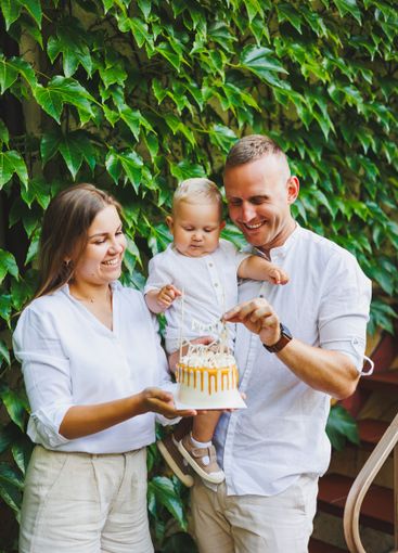Mom and dad in nature with their one-year-old son...