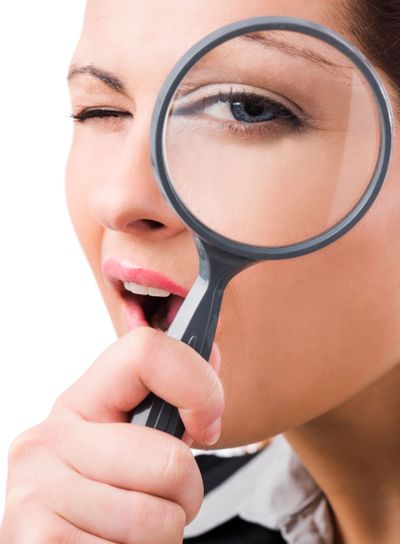 Business holding a magnifying glass