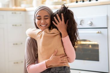 Happy Mother's Day. Little Girl Cuddling Tight Her...