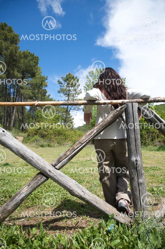 woman backwards on the fence