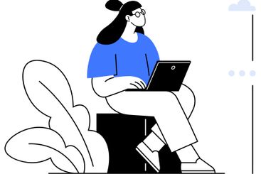 Woman Sitting on Block Using Laptop Surrounded by...