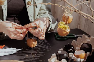 Female hands making egg shell handmade decoration for...