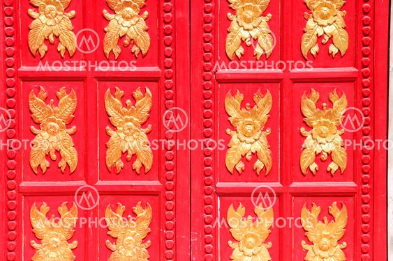 Flowers sculpture on red wooden window