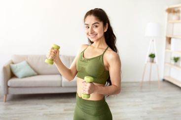 Home sports during covid quarantine. Happy Indian woman...