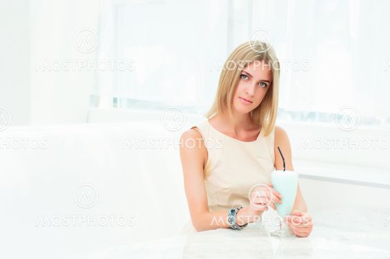 Portrait of a cute woman in a city cafe