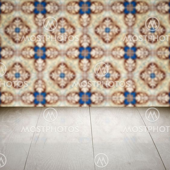 Wood table top and blur vintage ceramic tile pattern wall