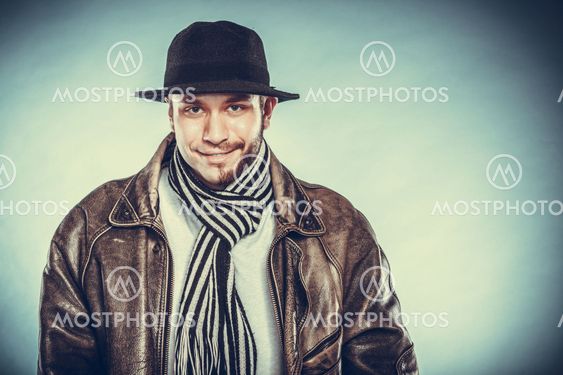 Happy man with half shaved face beard hair in hat.