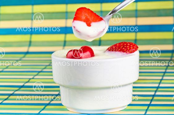 Yogurth in a spoon with strawberry