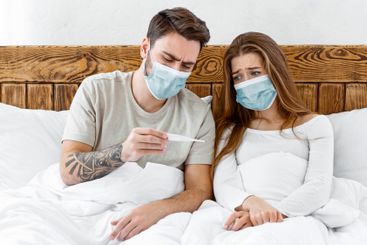 Quarantine together. Sad young man and woman in...