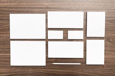 Blank stationery arranged on a wooden table for creative...