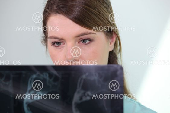 Nurse looking at X-ray
