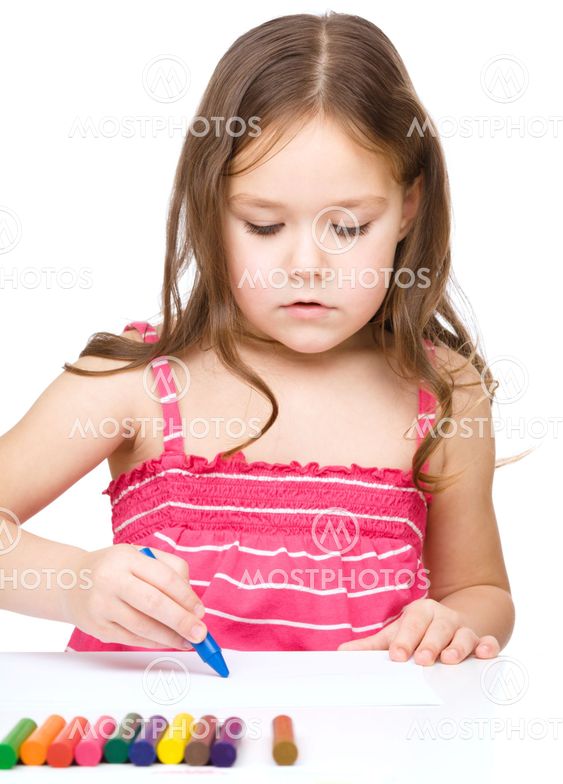 Little girl is drawing using a crayons