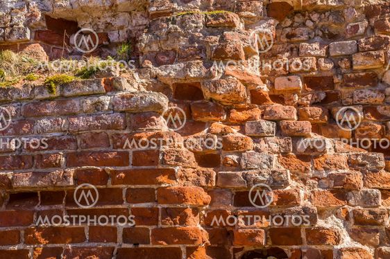 Fragment of old brick wall