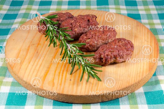 Cevapcici on a wooden dish