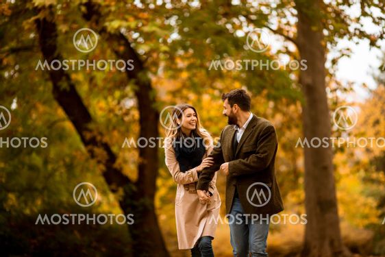 Young couple walking in the autumn park