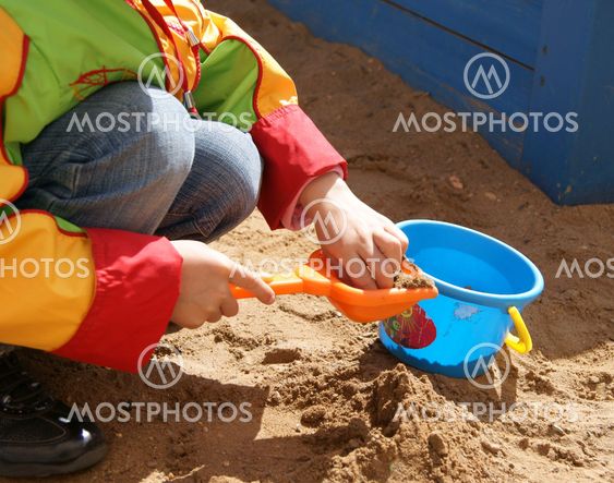 Child plays with sand