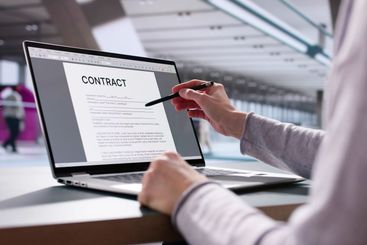 Young lady working as executive, reading contract paperwork