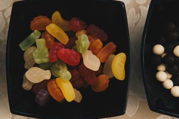 Close-up of coloured jelly beans in a black bowl