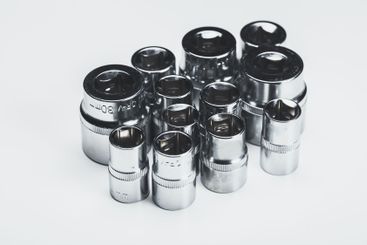 Collection of chrome socket tools arranged on a neutral...