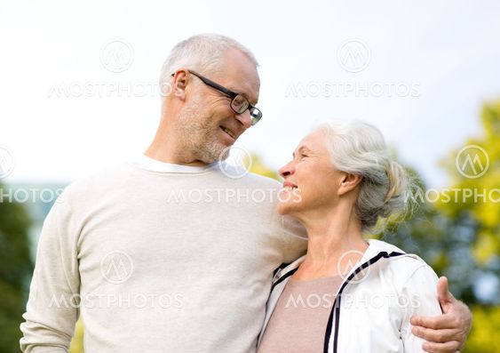 senior couple hugging in city park