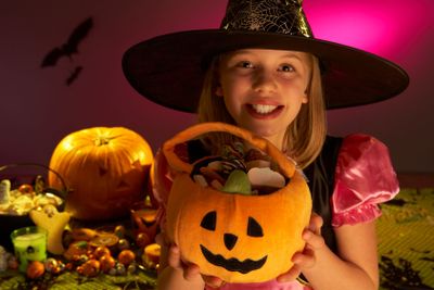 Halloween party with a child showing candy