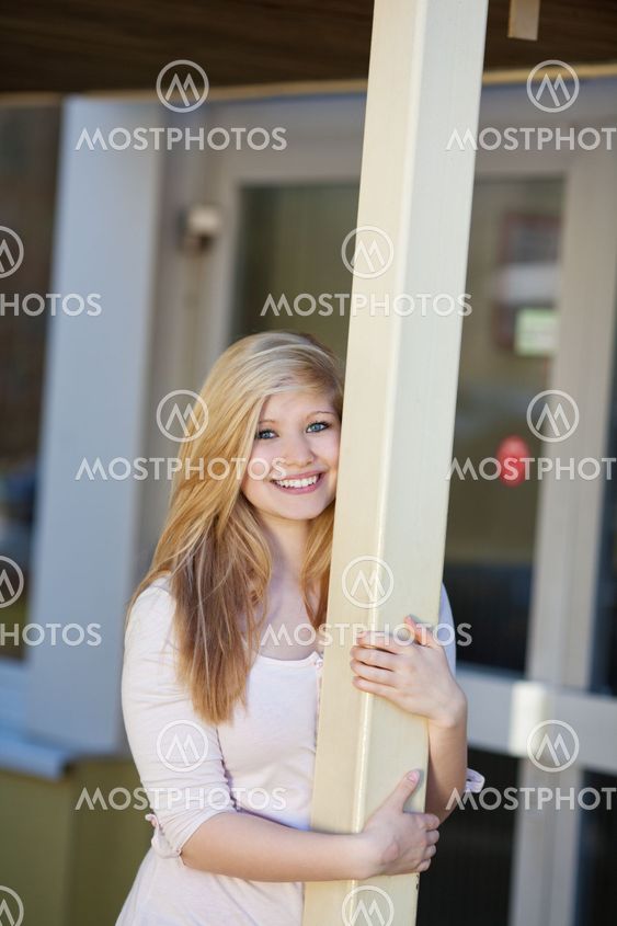 Beautiful young girl in front of the school