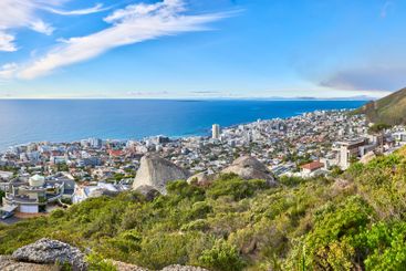 Beach, city and blue sky with mountain in nature for...