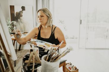 Creative, art and woman is painting in studio, palette...