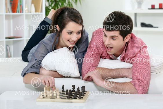 A couple of teenagers playing chess.