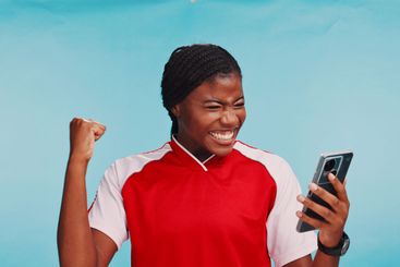 Black woman, phone and celebration in studio, sports and...