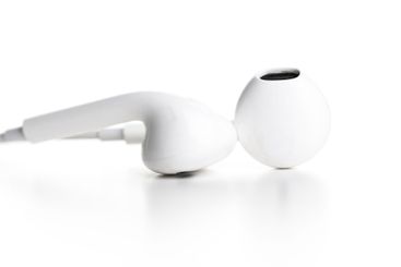 Pair of earphones close up on grey background