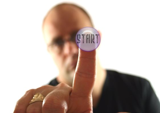 Man Pressing the Start Button