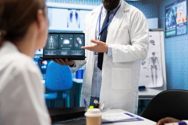 Physician presenting a ct scan result for heart and...