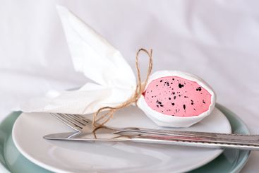 Decorative rabbit made from egg and napkin on a plate on...