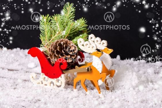 composition of Christmas decoration reindeer and Santa sleigh with branch fir tree, pinecones in traces snow on black background, closeup