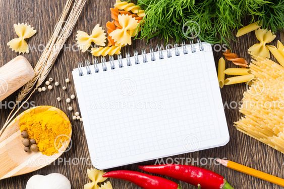 spices and vegetables around notebook