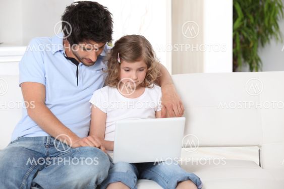 Father and daughter using a laptop