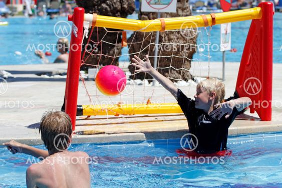 Boys with ball in pool 2
