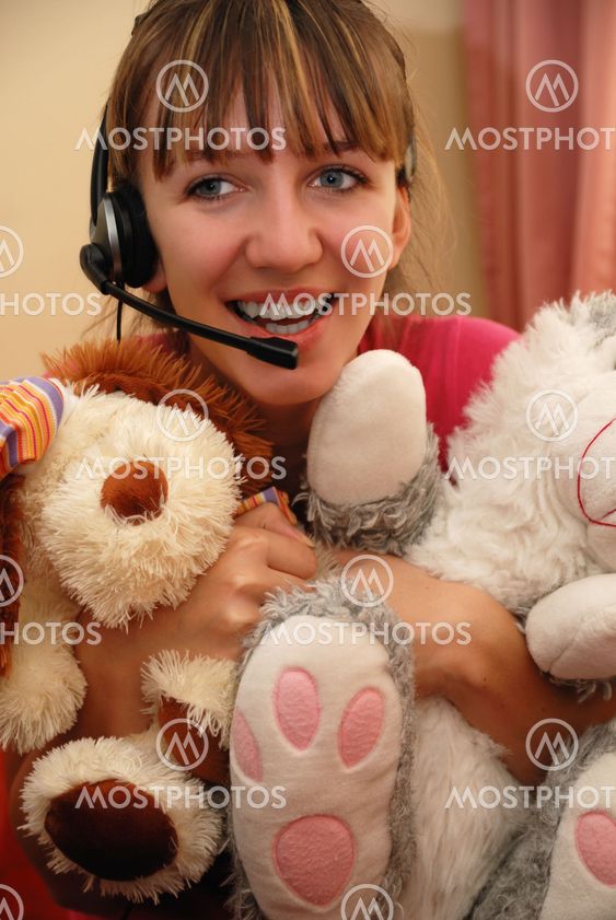 Cute young woman huging toys
