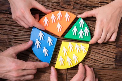 Businesspeople Connecting Pie Chart With Human Figures 