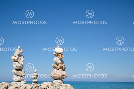 Blue ocean background with a pillar of stones for meditative or spiritual concepts